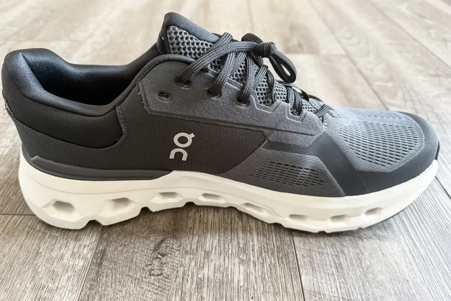 A side view of the On Running Men's Cloudrunner 2 Wide Running Shoe