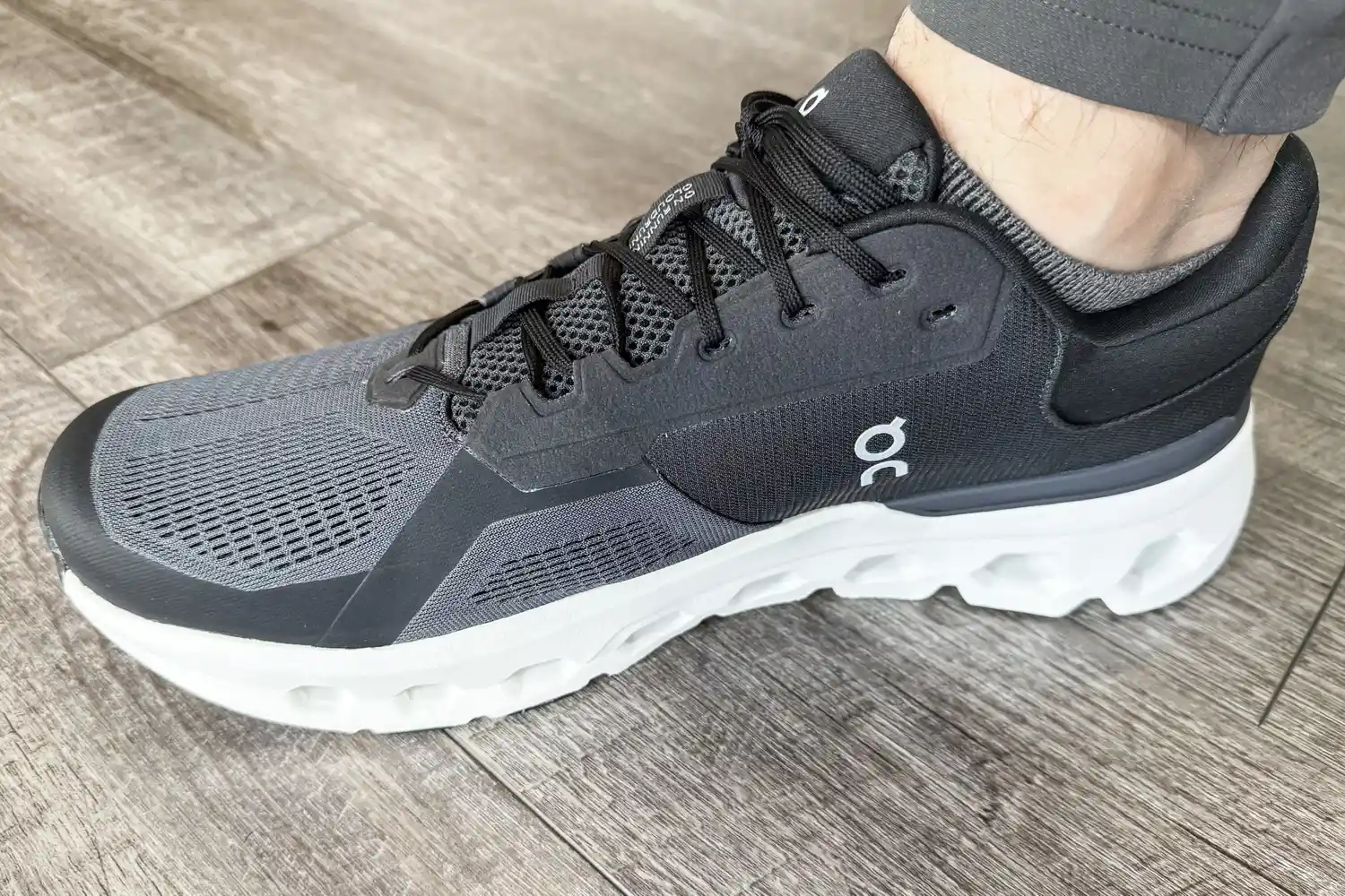 A person wears the On Running Men's Cloudrunner 2 Wide Running Shoe