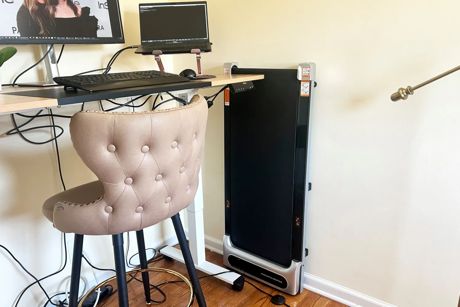 The Orinar 3-in-1 Walking Pad stored vertically against a wall