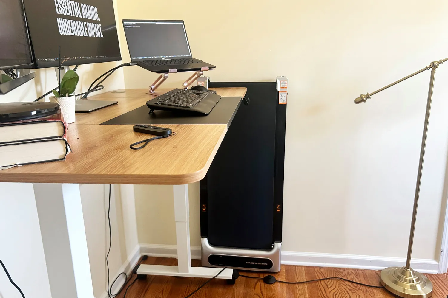 The Orinar 3-in-1 Walking Pad stored vertically against a wall