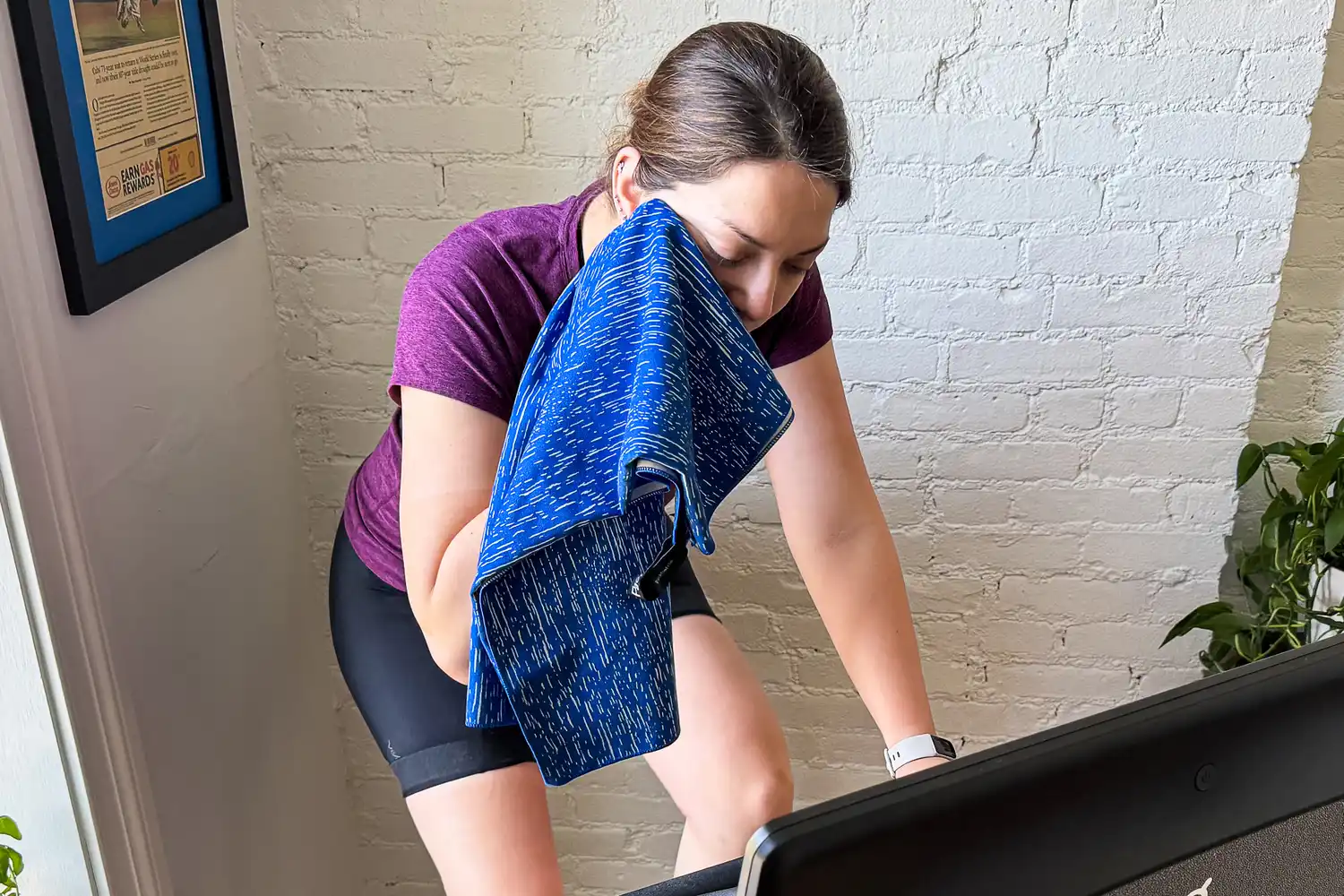 A person wipes their face using the PackTowl Personal Quick Dry Microfiber Towel