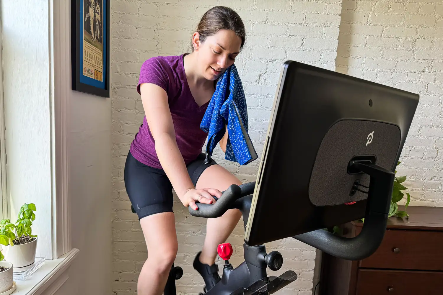 A person uses the PackTowl Personal Quick Dry Microfiber Towel while exercising