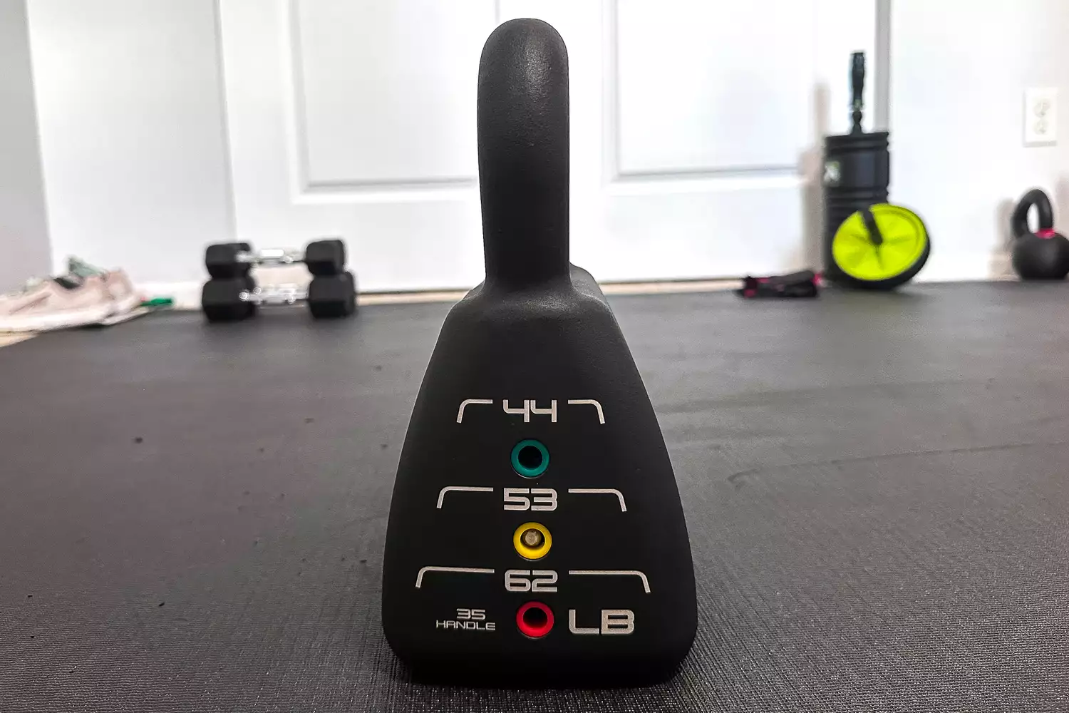 The PowerBlock Adjustable Kettlebell Weight Set on a mat