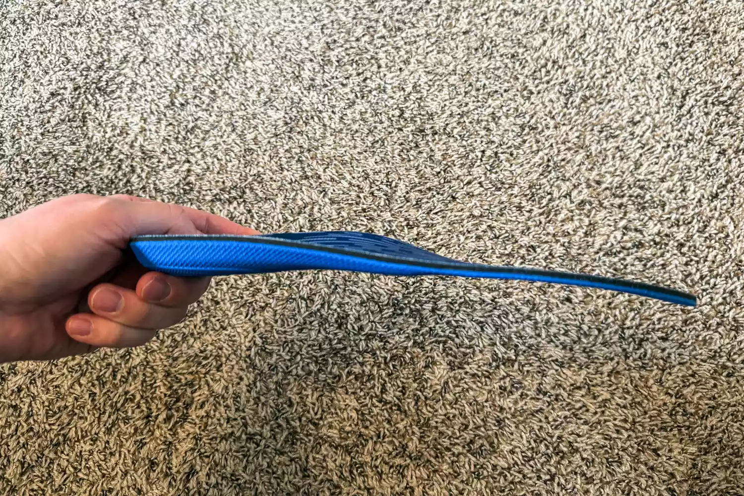 A person holds up the PowerStep Pinnacle Low Insole