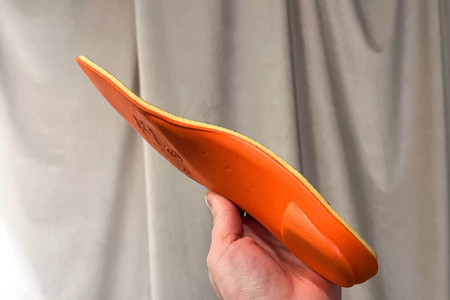 A person holds up the PowerStep PULSE Maxx Insole