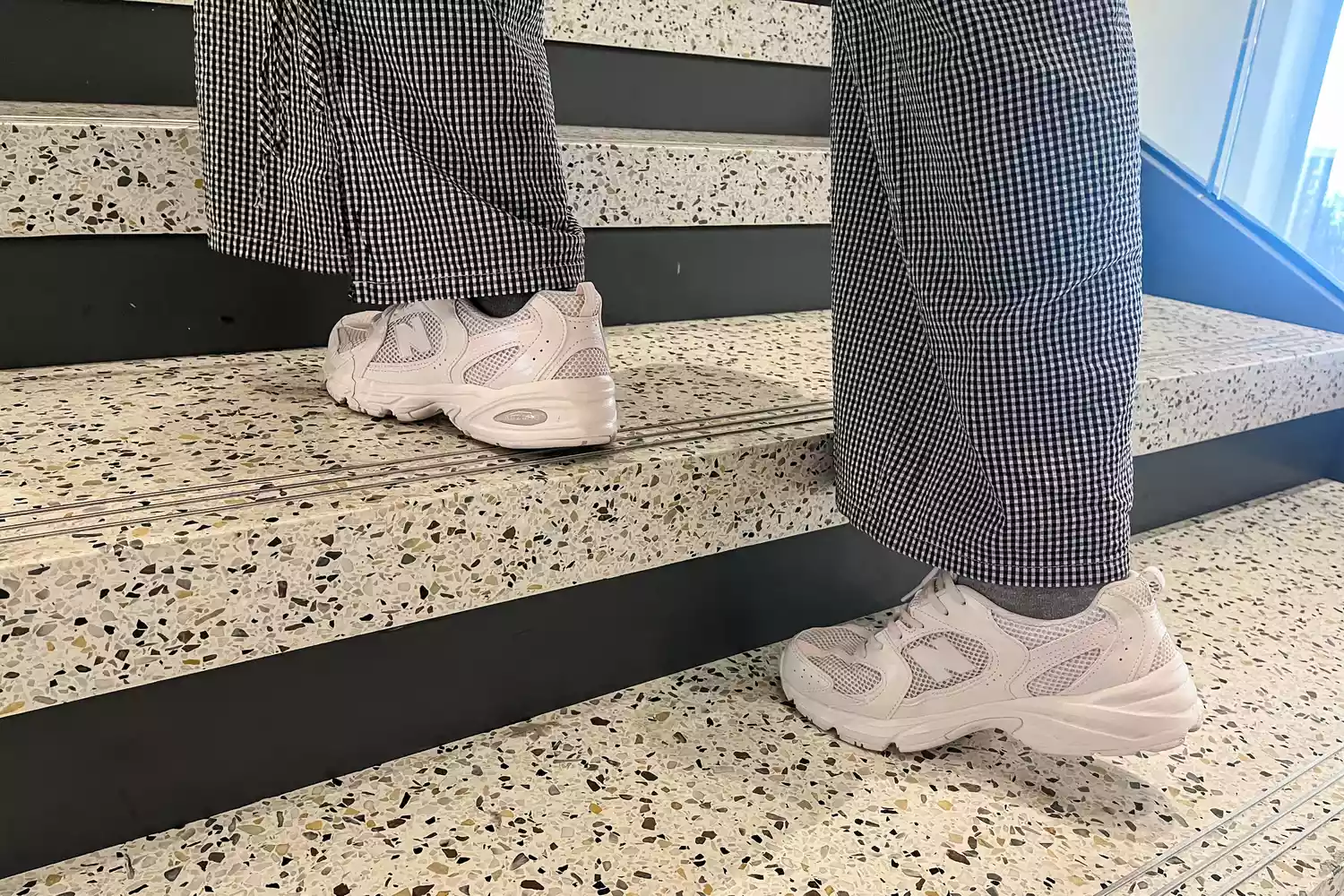 A person walks up stairs while wearing the PowerStep PULSE Maxx Insoles