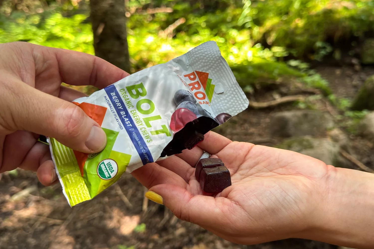 A person prepares to eat Probar BOLT Organic Energy Chews