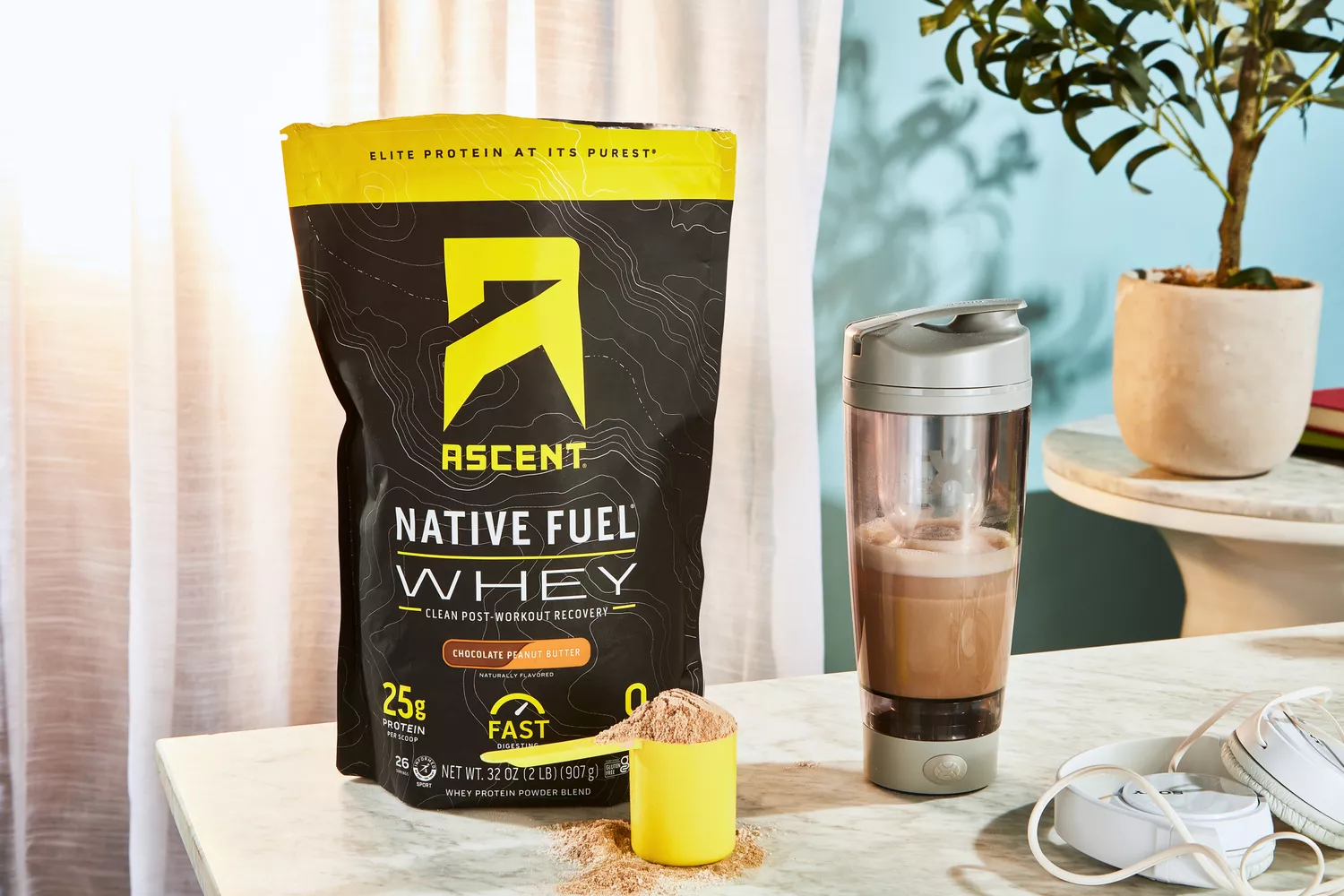 Ascent Native Fuel Whey Protein Powder displayed on a counter