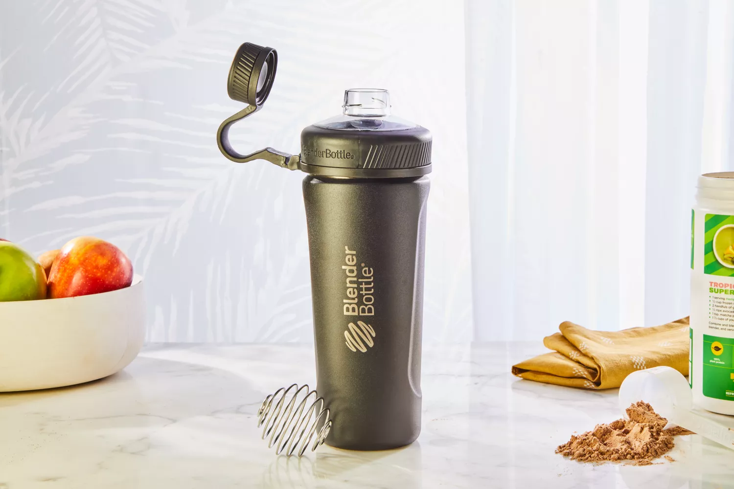 BlenderBottle Radian 26 oz Shaker Cup displayed on counter with fruit and protein powder 