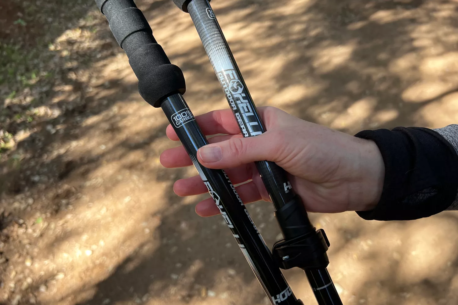 Person holding Foxelli Carbon Fiber Trekking Poles