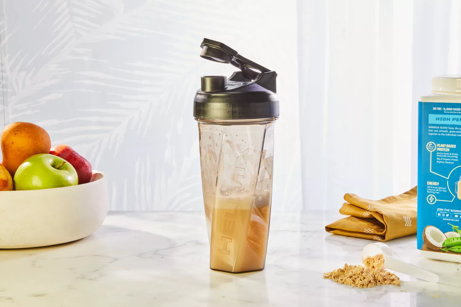 Helimix Vortex Blender Shaker Bottle displayed with fruit and powder