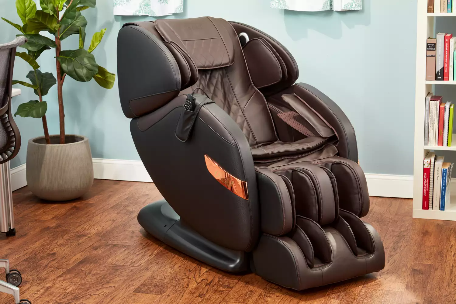 An Osaki OS-Champ Massage Chair in a room with blue walls and a bookshelf