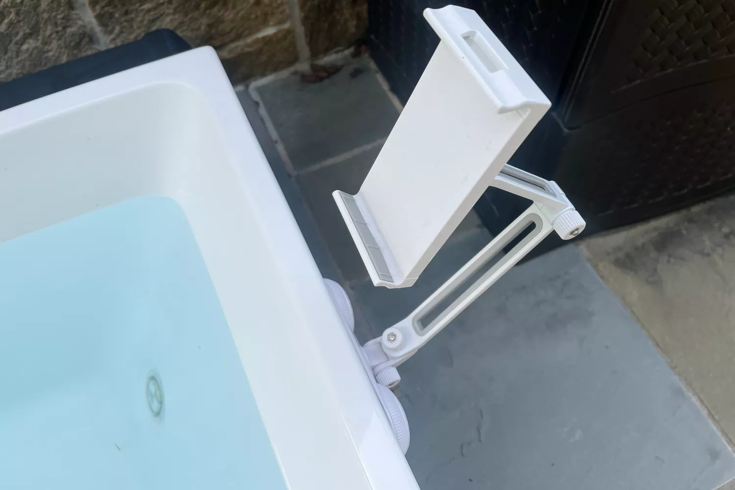 A cloeup of the phone/tablet holder attached to the PLUNGE cold tub