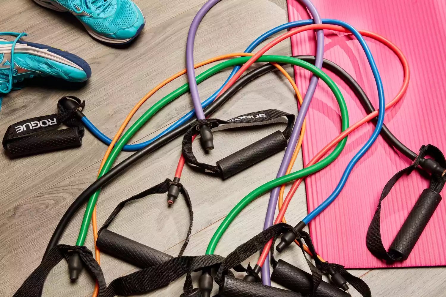 Rogue Tube Bands on a pink yoga mat with blue sneakers in background