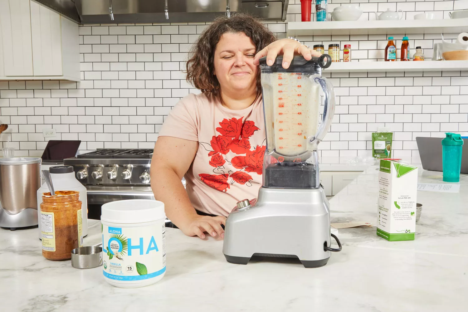 Person mixing Aloha Vanilla Organic Plant Based Protein Powder using mixing machine