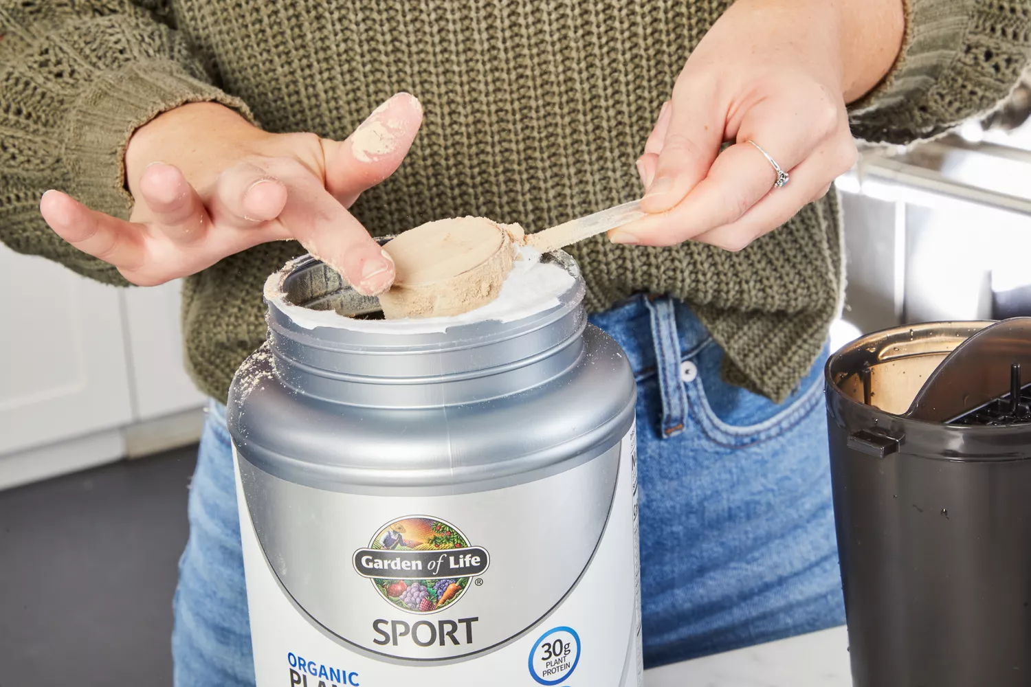 Hands scooping Garden of Life SPORT Organic Plant-Based Protein