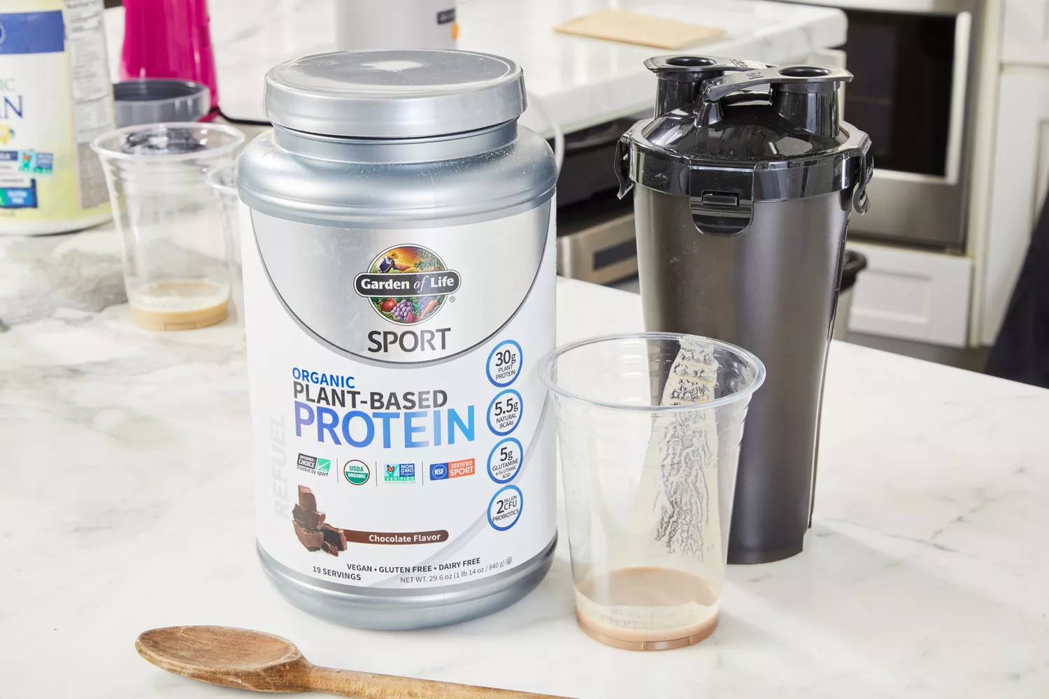Garden of Life SPORT Organic Plant-Based Protein with shaker and glass displayed on counter