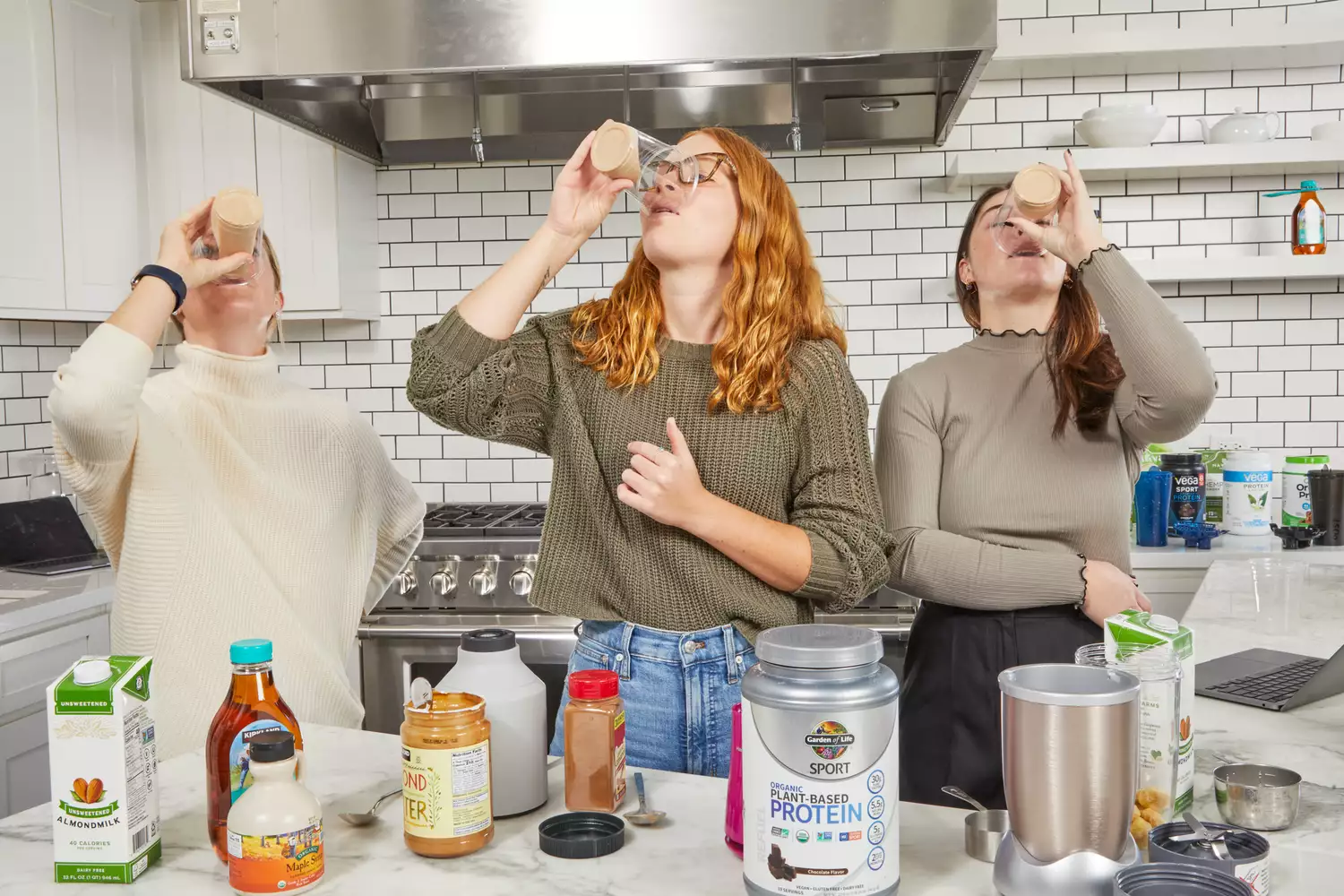 Three people drinking protein shakes made with Garden of Life SPORT Organic Plant-Based Protein powder