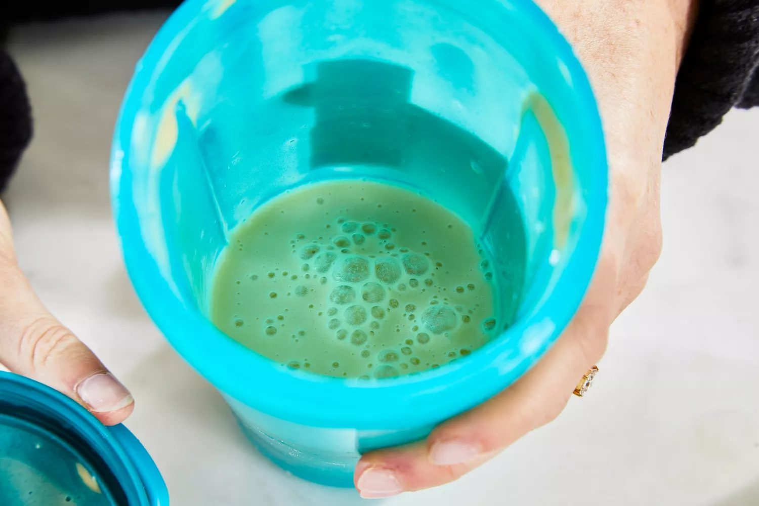 A glass of Ritual Essential Protein Daily Shake Protein Powder