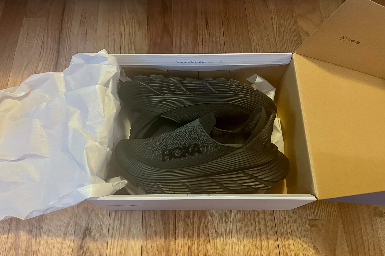 The Hoka Restore TC Recovery Shoes in the box