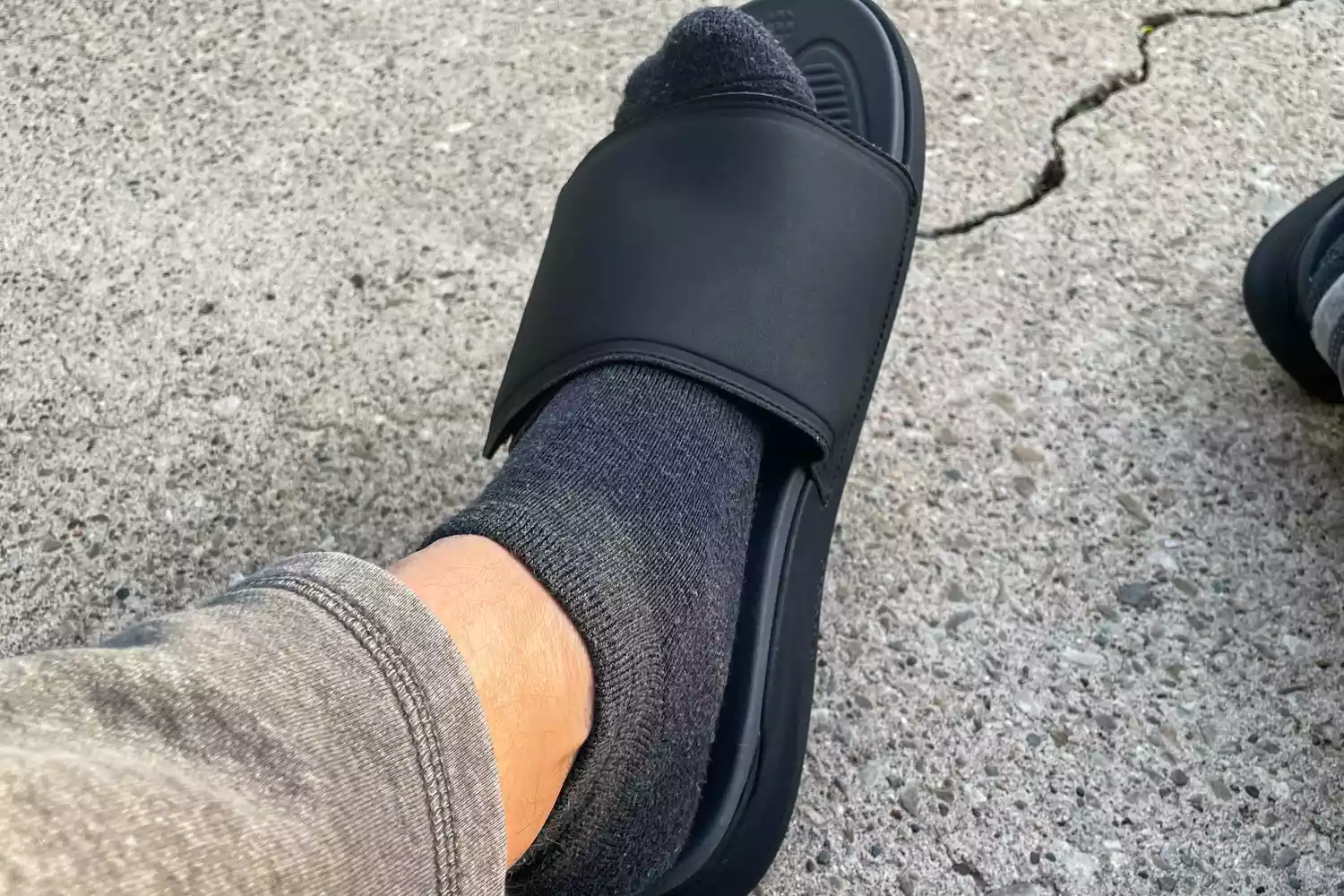 A person's foot inside the Kuru Men's Moment Slide Sandal