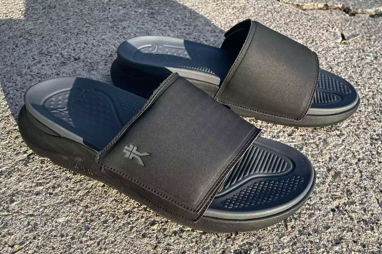 The Kuru Men's Moment Slide Sandal on concrete