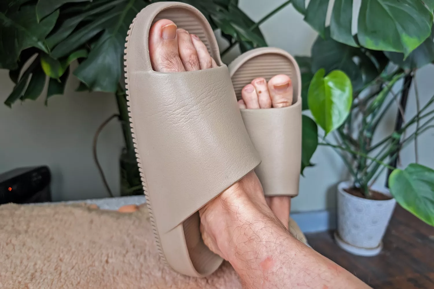 A person wears the Nike Calm Men's Slides