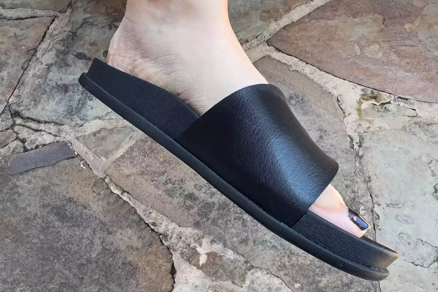 A person wears the Reef Women's Cushion Soho Cruz Sandals