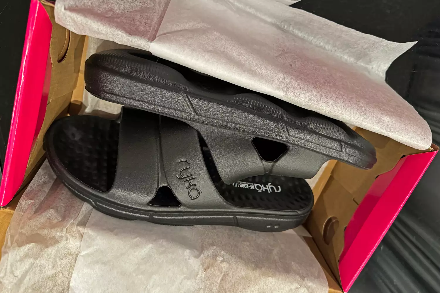 The Ryka Women's Restore Recovery Slides inside the shoebox before use
