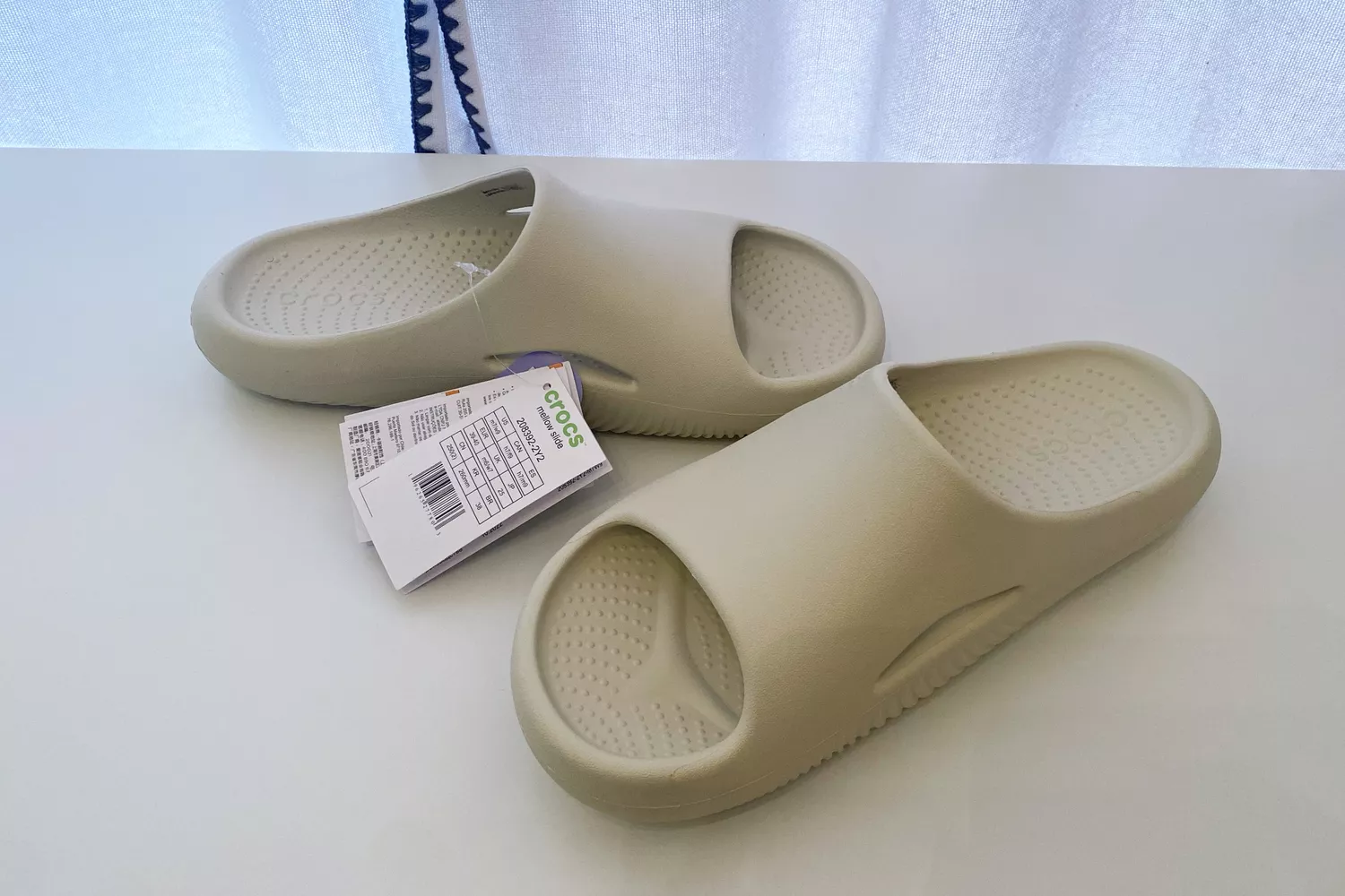 Crocs Mellow Recovery Slide with tags on white table