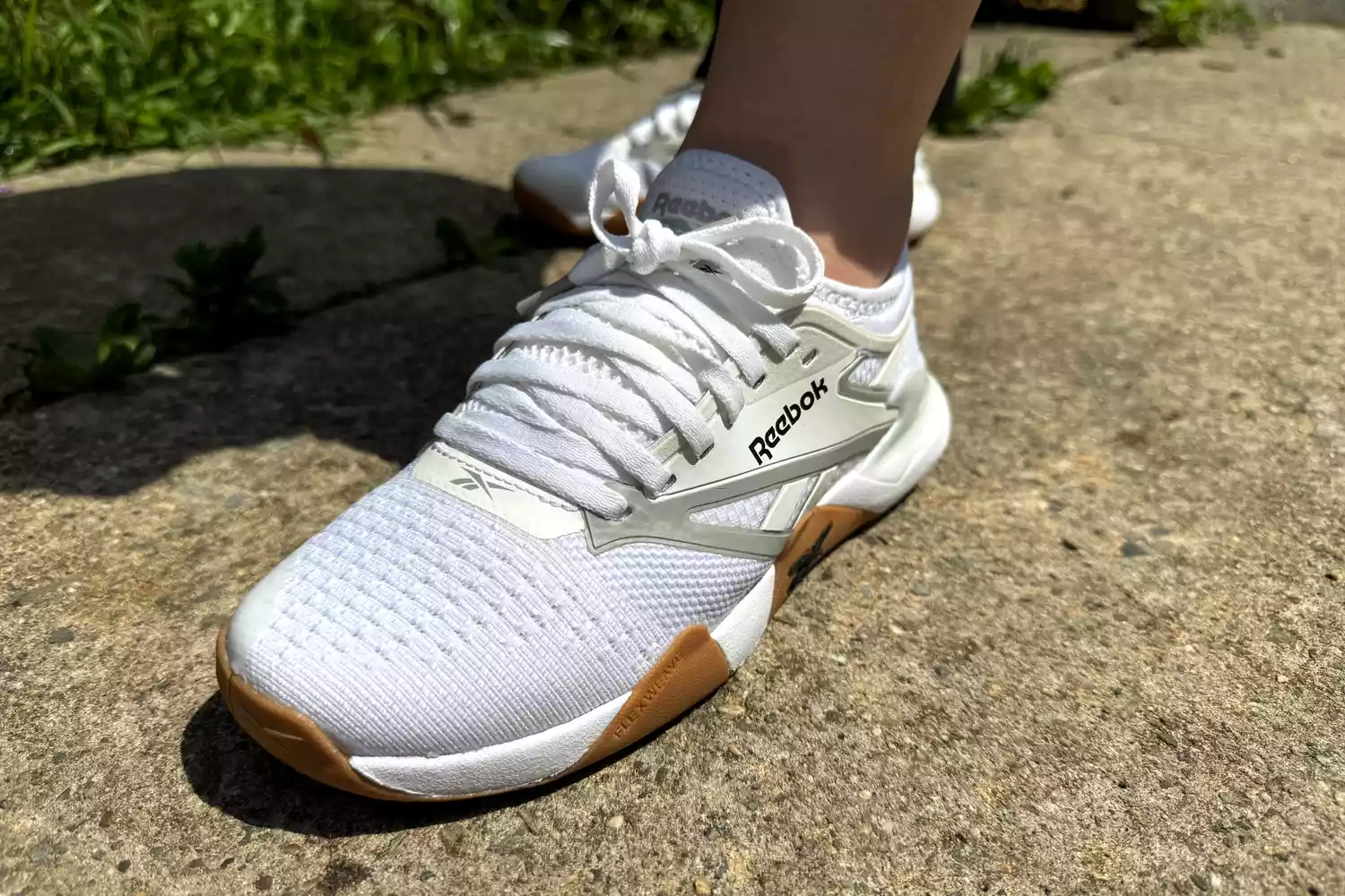 A close-up of the Reebok Nano Court sneaker on concrete
