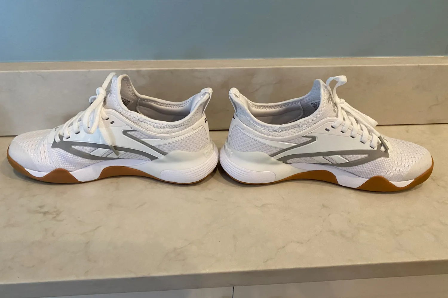 A side view of a pair of Reebok Women's Nano Court Shoes