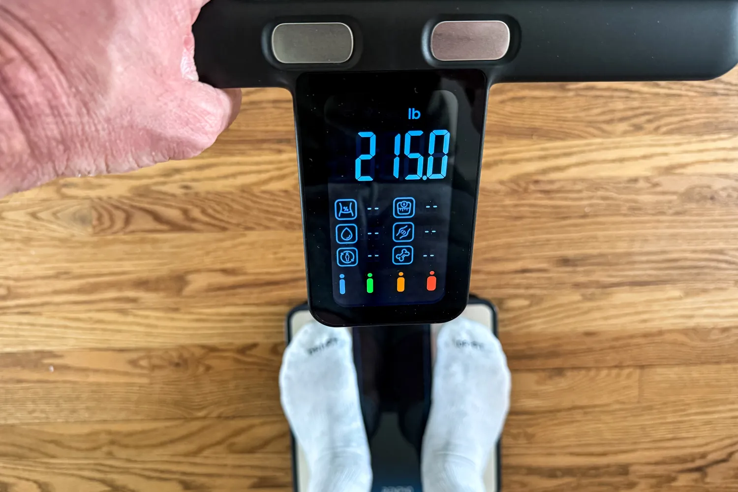 A person stands on the Renpho MorphoScan Smart Body Scale in socks
