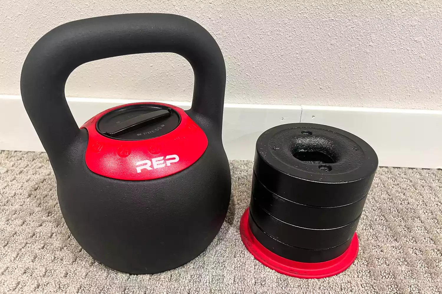 The REP Fitness Adjustable Kettlebell with Matte Powder Coating with additional weights