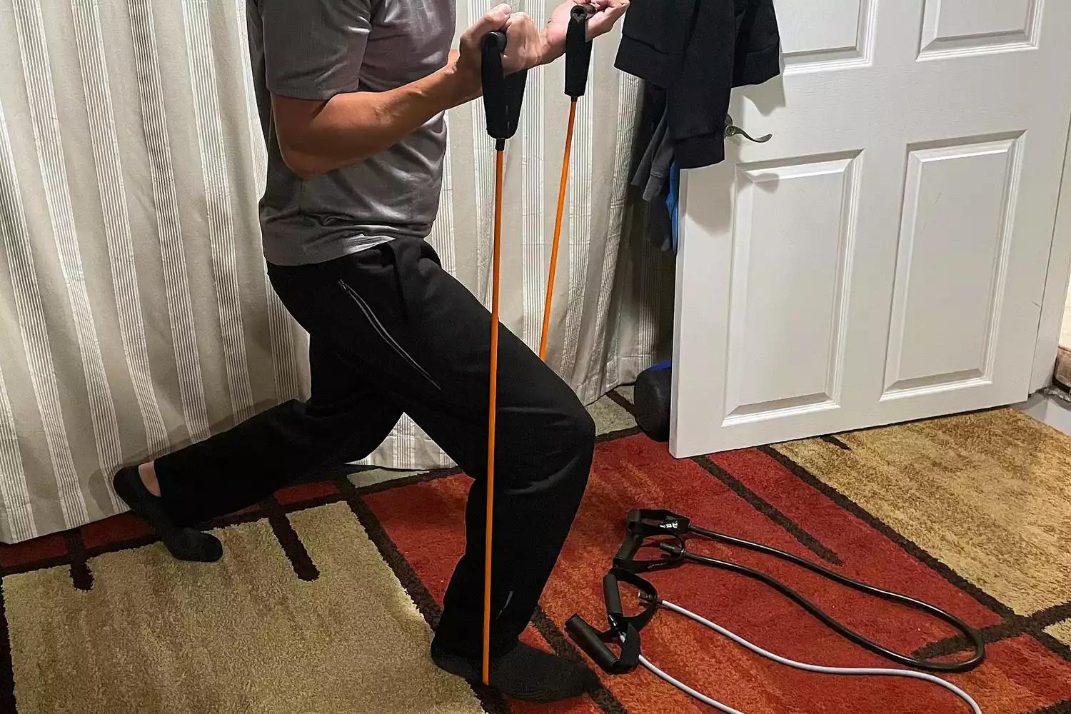 A close-up of a person using the Rep Fitness Tube Resistance Bands with Handles