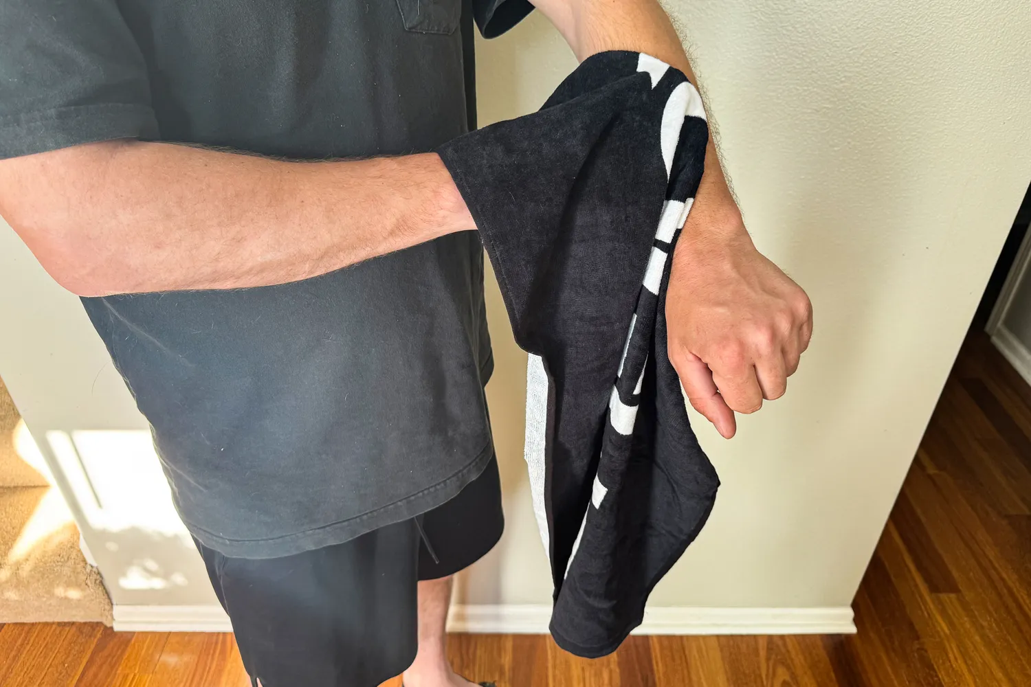 A person wipes their arm using the Rogue Gym Towel