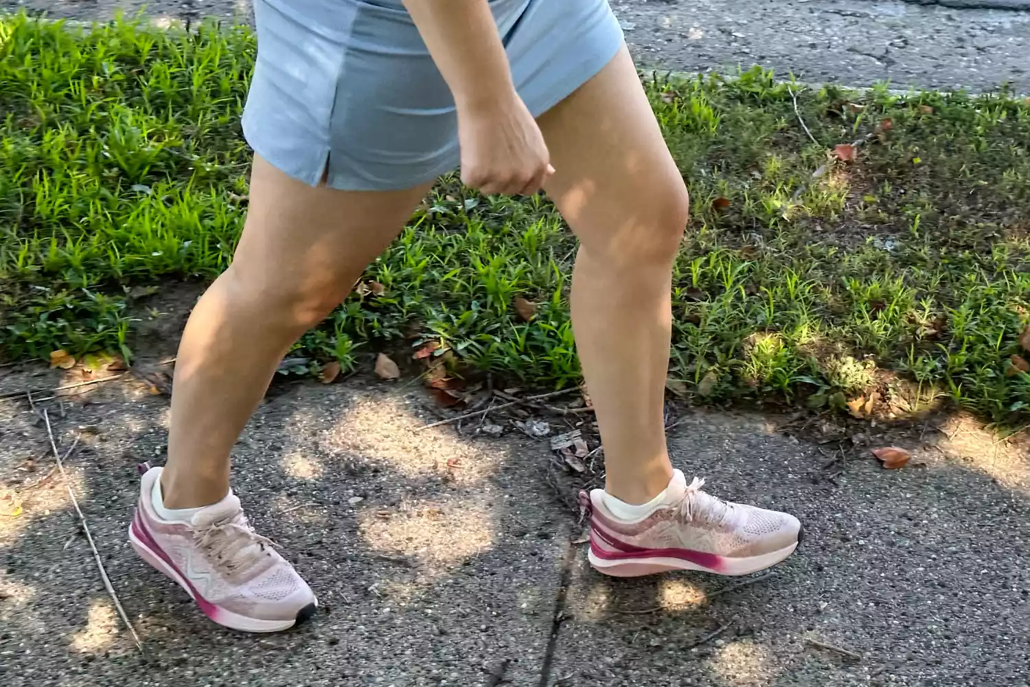 A person walking while wearing MBT Huracan 3000 Running Shoes