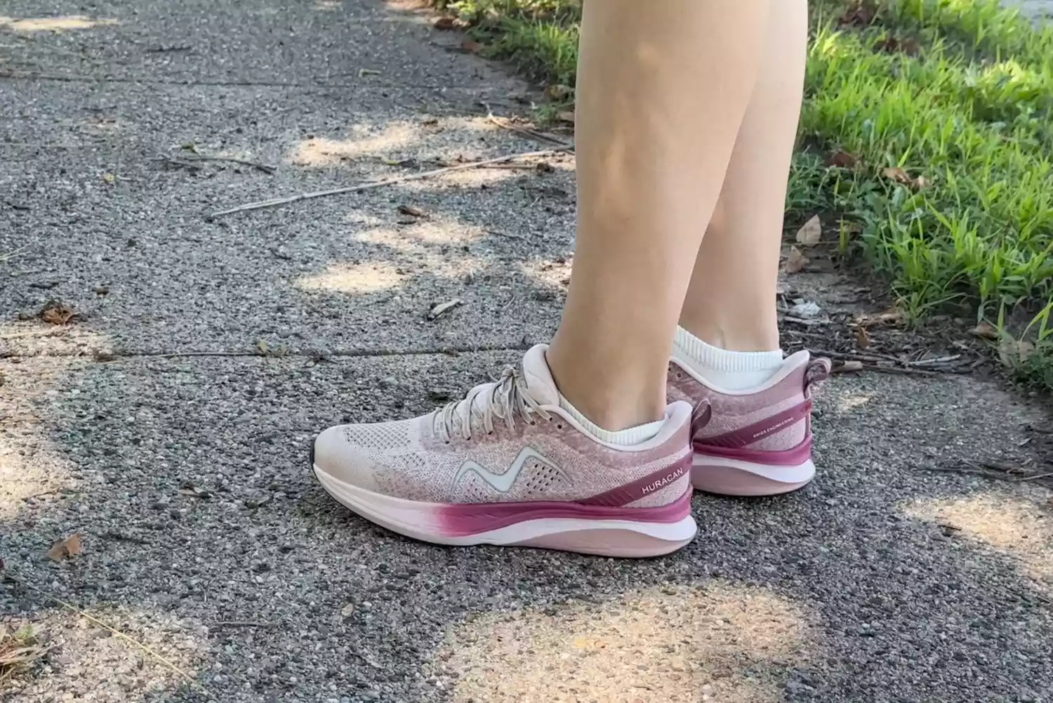 A side view of a person standing outside while wearing MBT Huracan 3000 Running Shoes