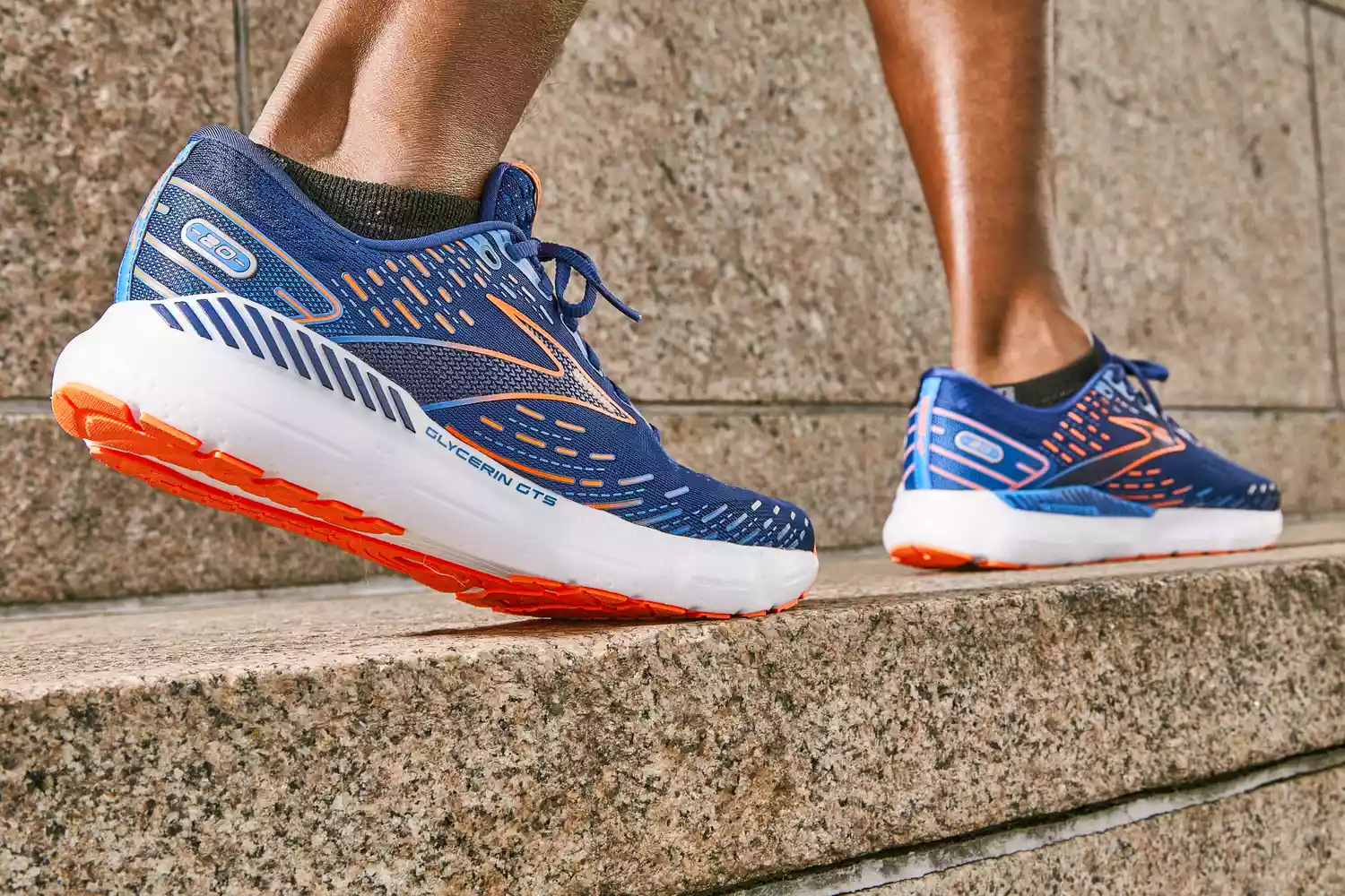 A close up of a person wearing Brooks Men's Glycerin GTS 20 Running Shoes outdoors