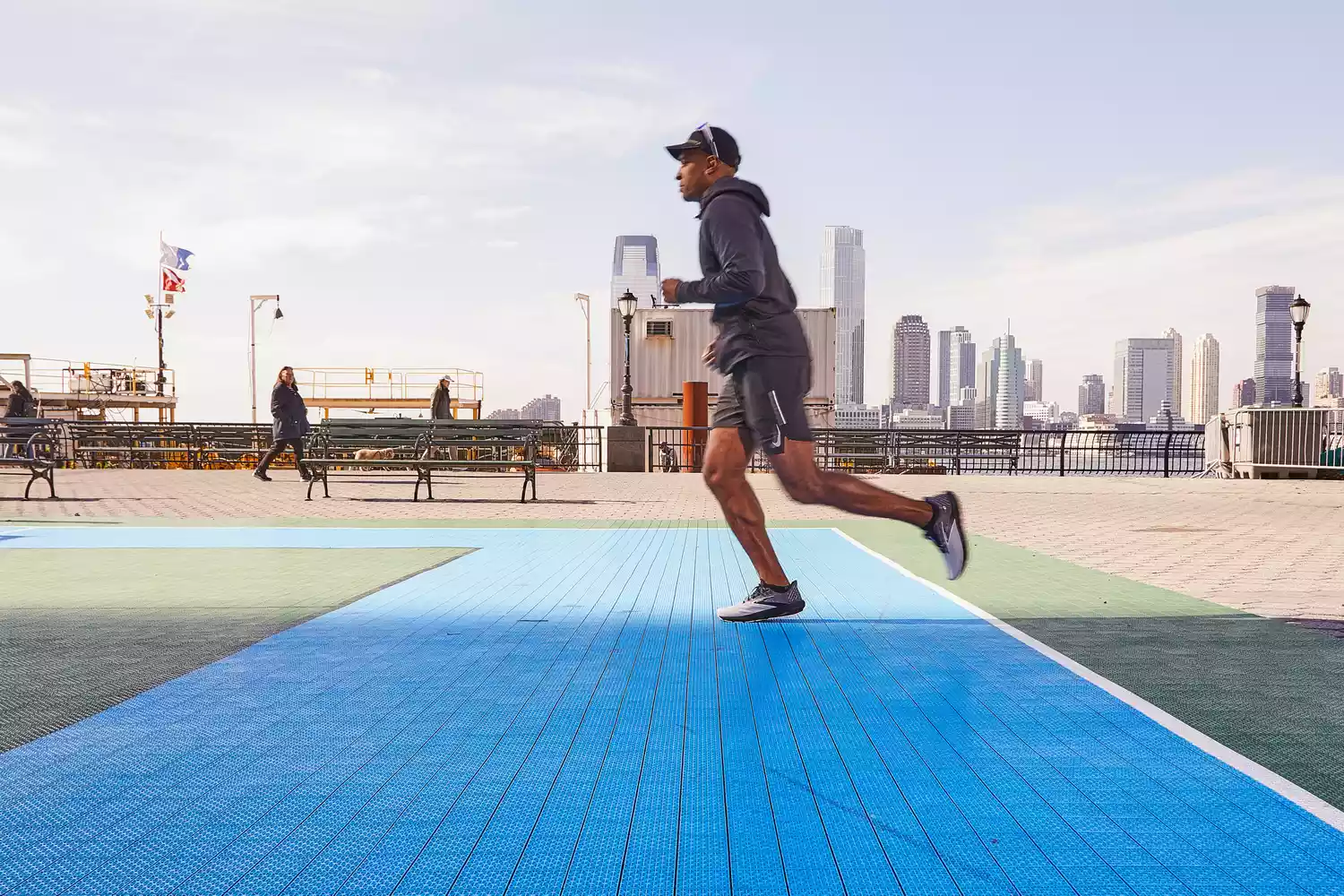 A person running on an outdoor court wearing the Brooks Launch 10