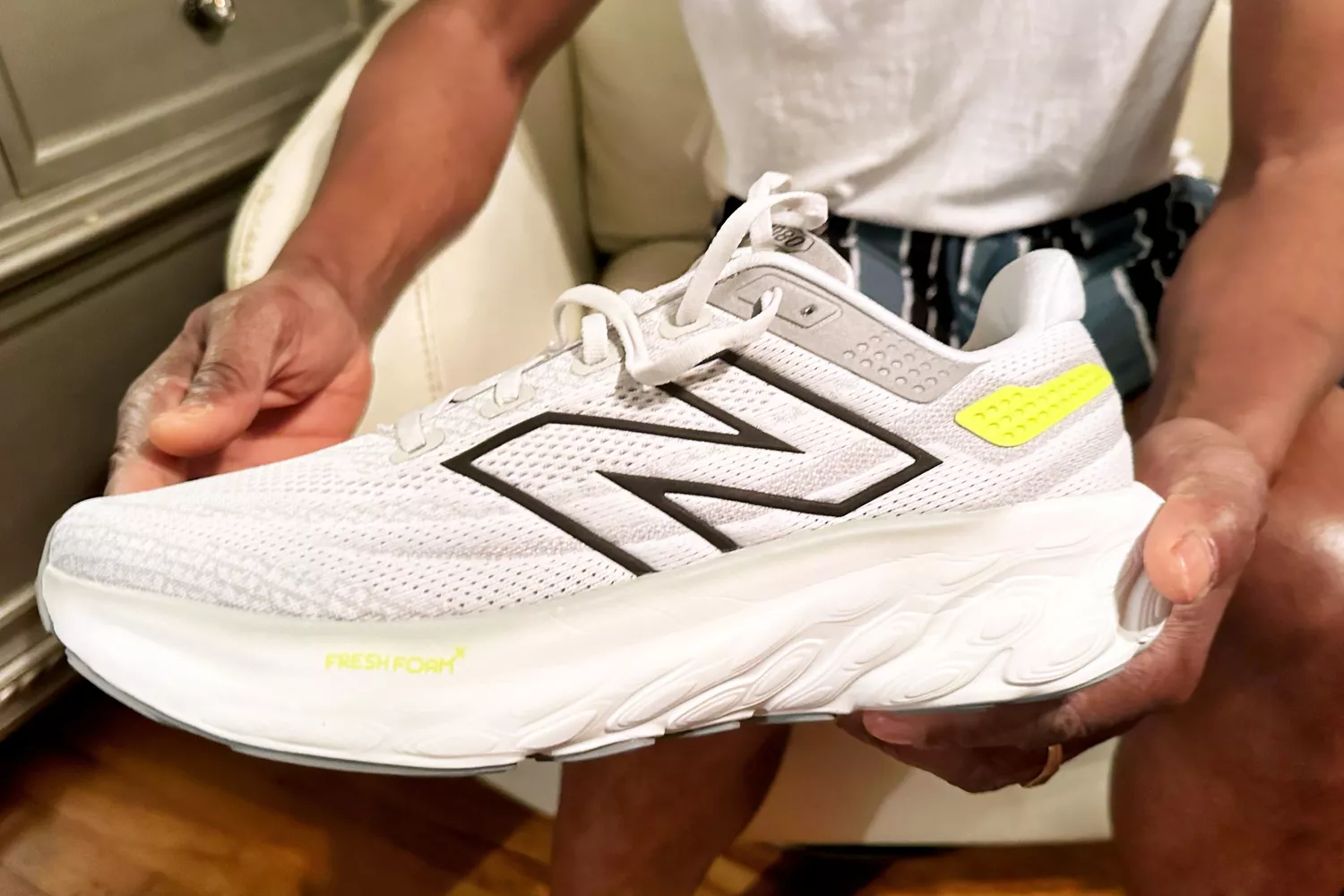 A person holds up the New Balance Women's Fresh Foam X 1080v13 Running Shoe