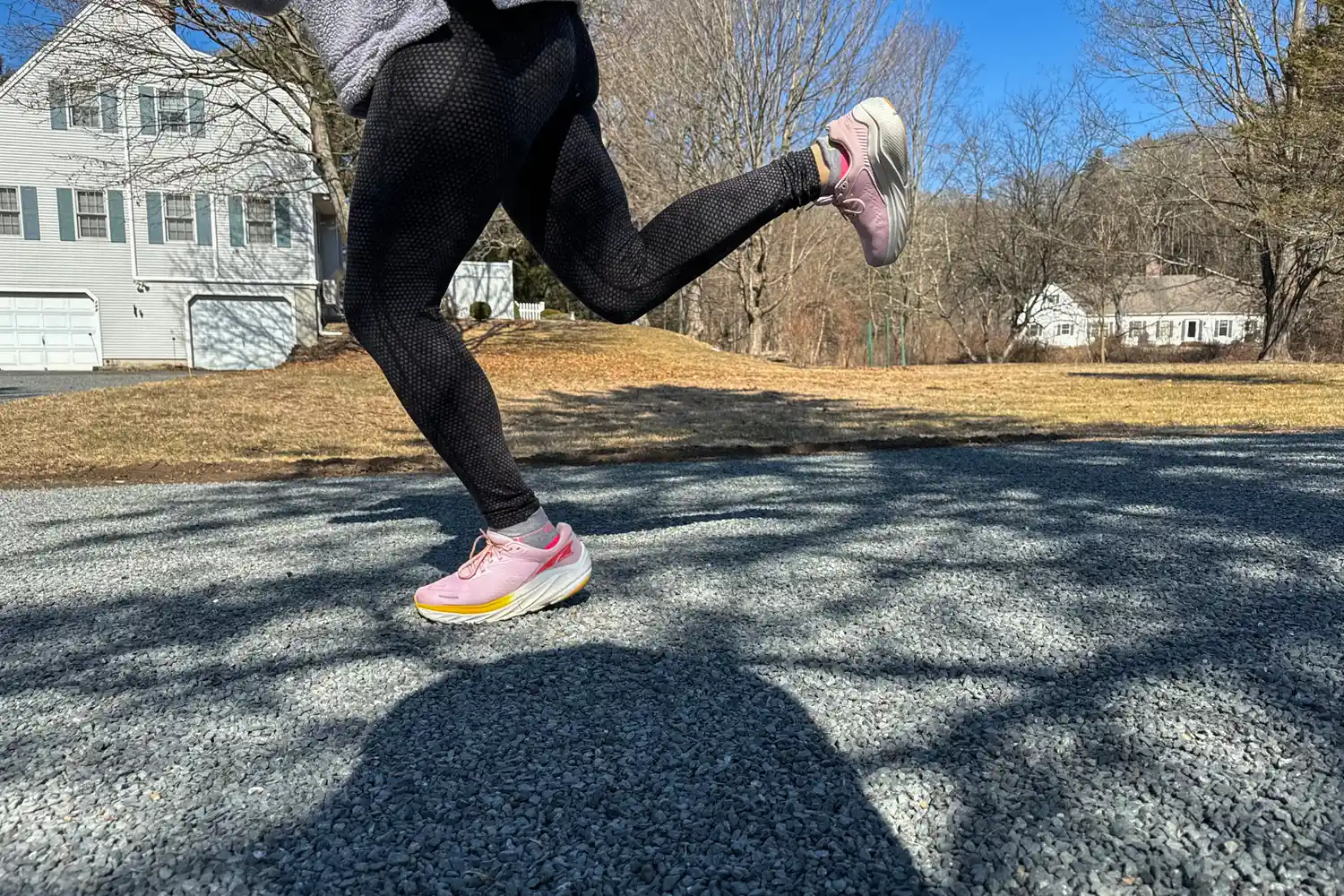 A person runs outside while wearing the Altra Women's Via Olympus 2 Running Shoes