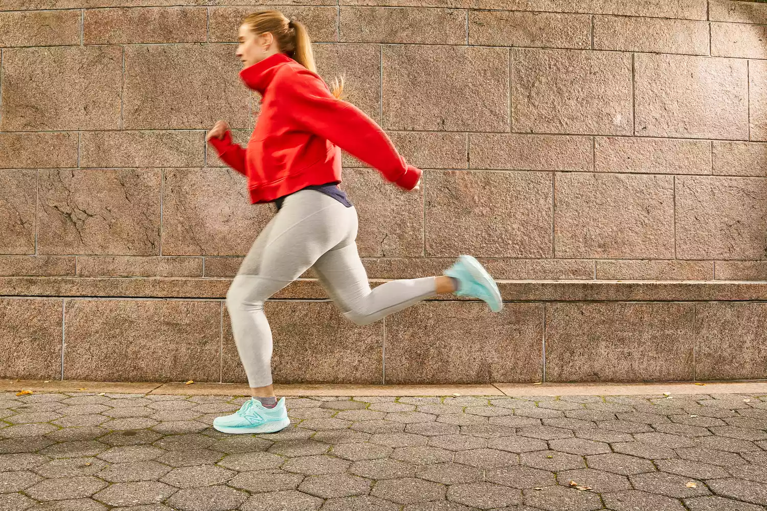 Person running outdoors wearing New Balance Women's Fresh Foam X 1080 v13