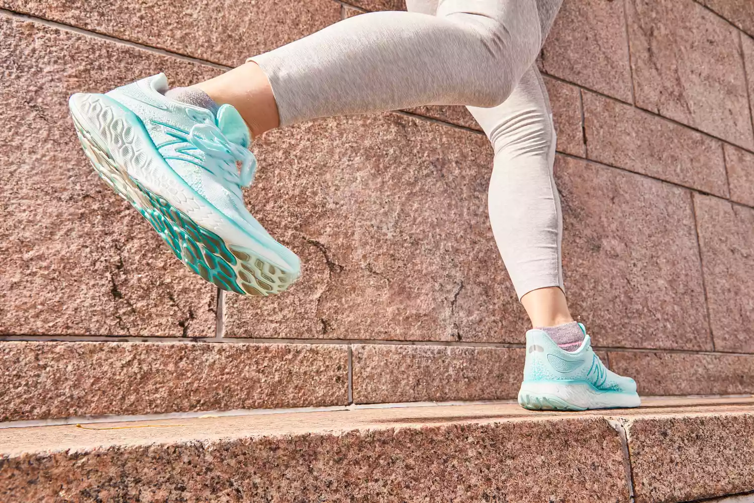 Person running outdoors wearing New Balance Women's Fresh Foam X 1080 v13