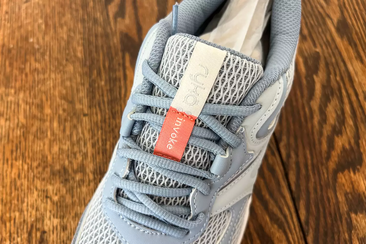 An overhead view of a Ryka Women's Invoke Walking Shoe on a wooden surface