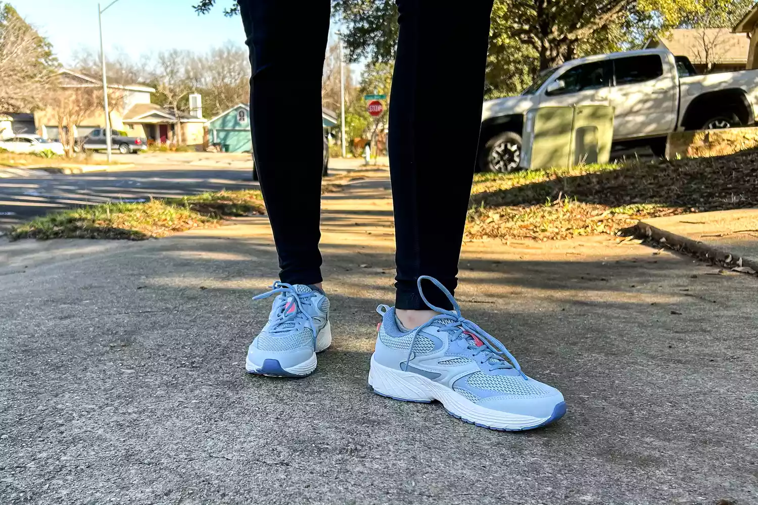A person's legs posed while wearing the Ryka Women's Invoke Walking Shoes in grass