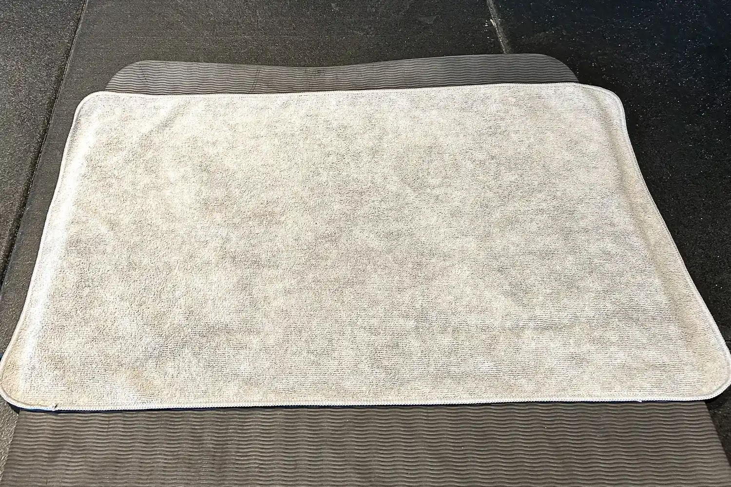 The S&T INC. Microfiber Sweat Gym Towel on a yoga mat