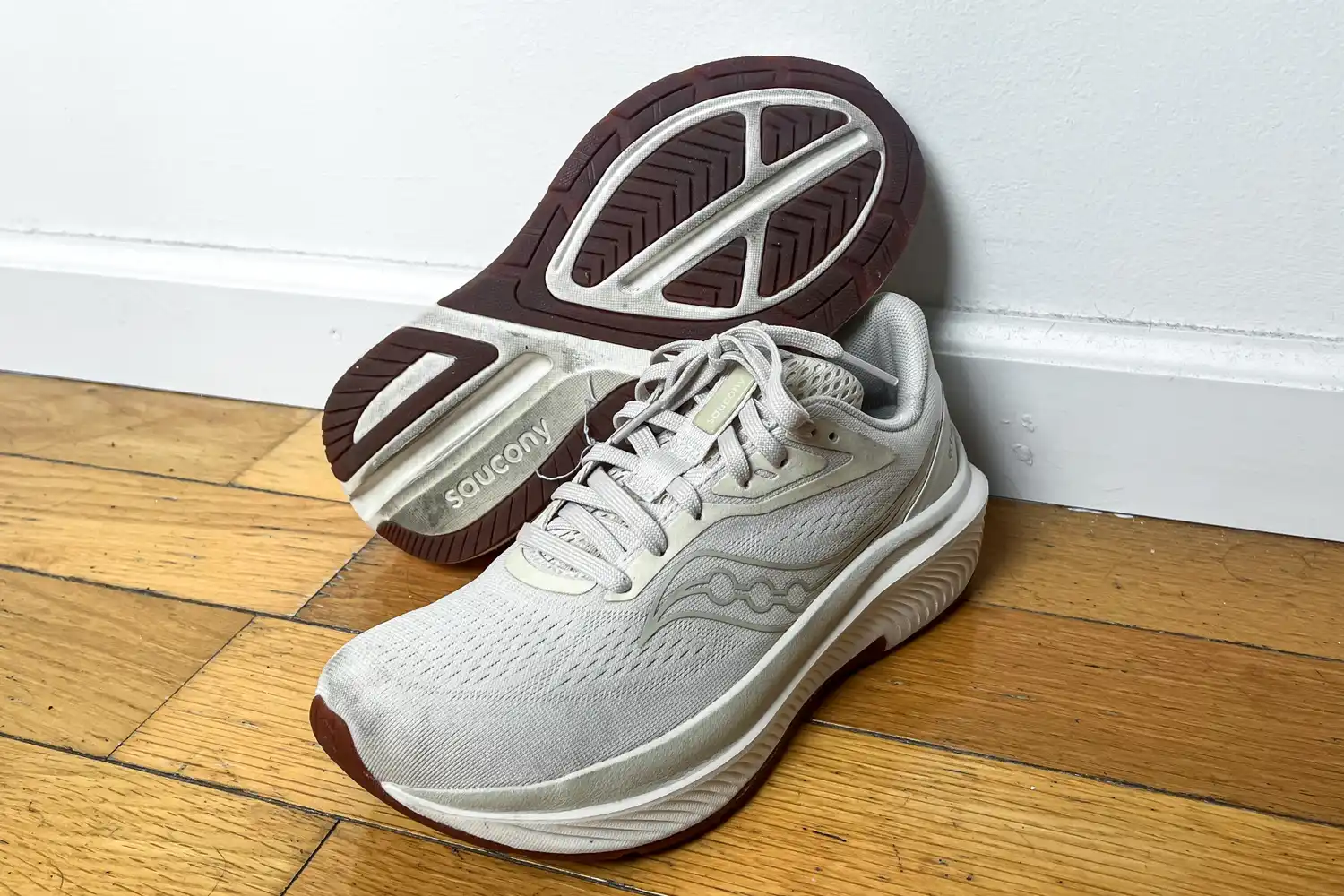 A pair of Saucony Women's Echelon 10 Running Shoes next to a wall