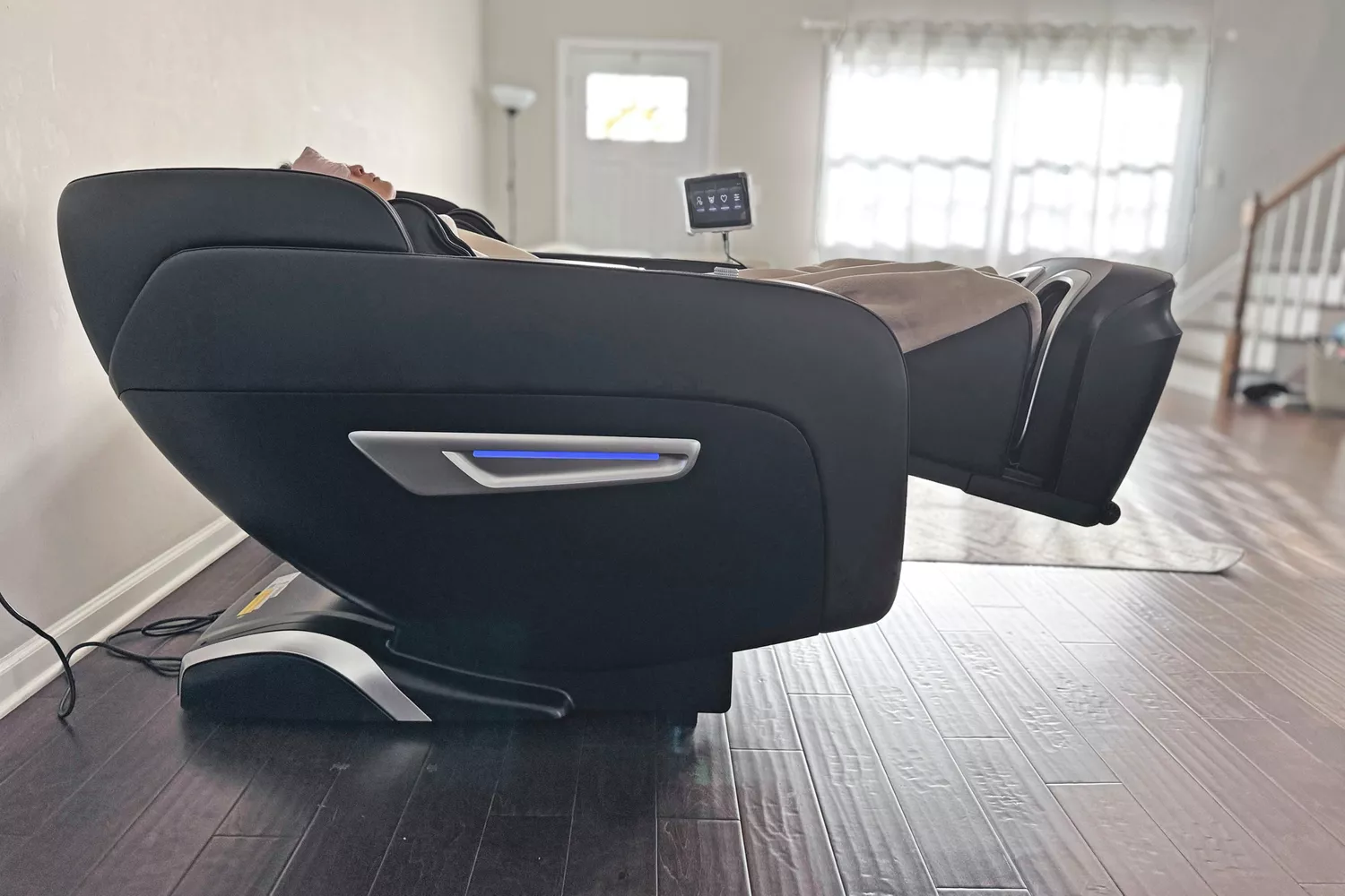 A person in the SCS Make Life Easy Lifesmart R775W 4D Massage Chair from a side angle