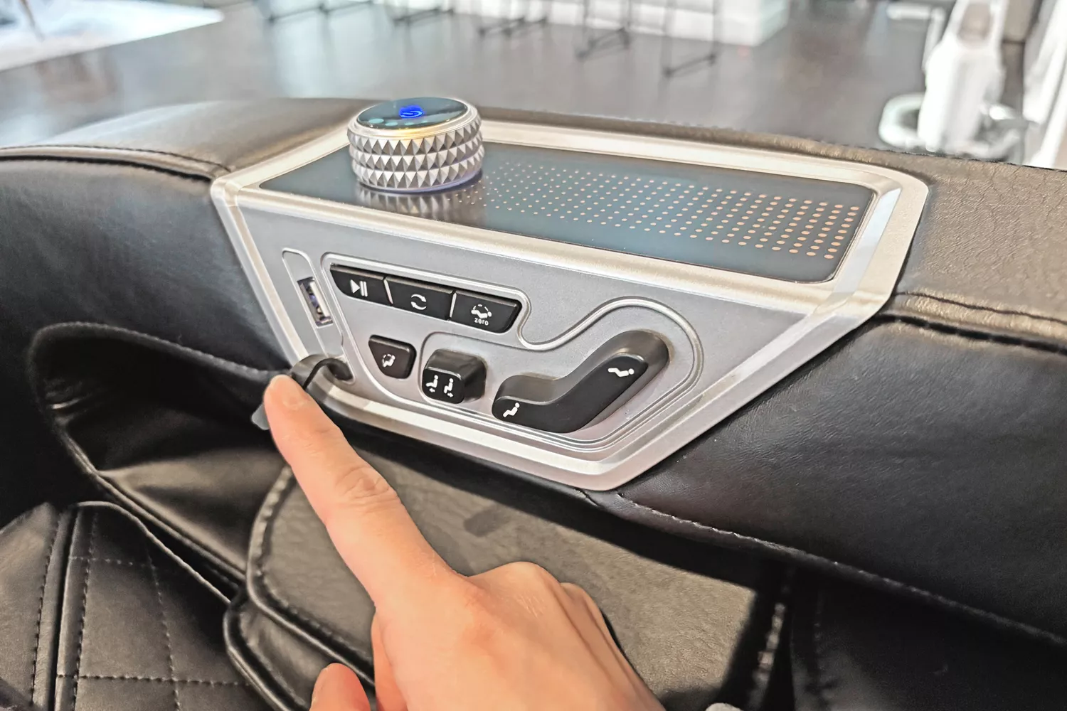 A finger touching part of the SCS Make Life Easy Lifesmart R775W 4D Massage Chair